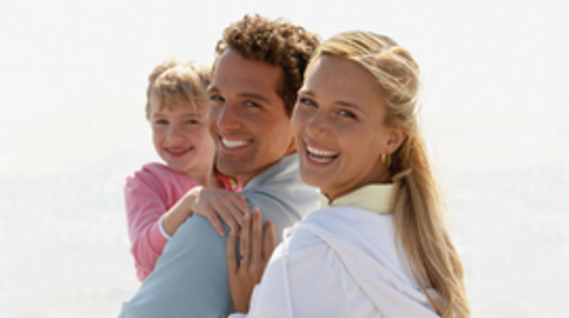 Family smiles at the camera