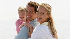 Family smiles at the camera