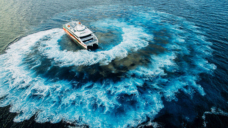 High speed craft Halunder Jet driving in a circle on the water.