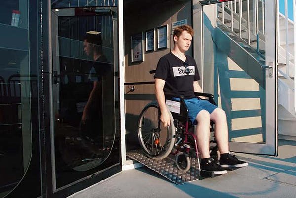 A person with a wheelchair getting on deck 