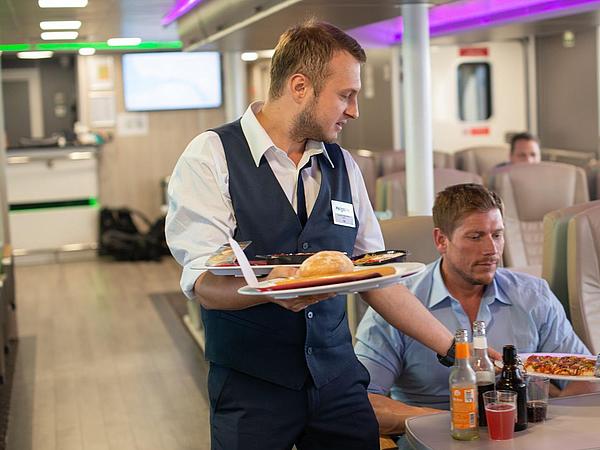 Steward handing out guest's gastronomic order on board