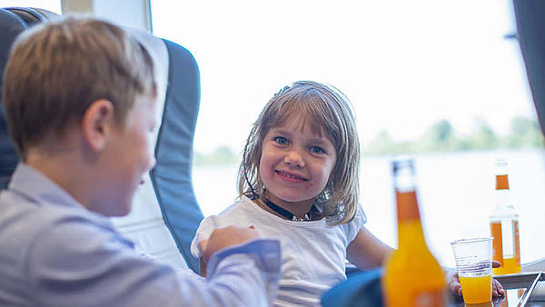 Two children on board having a soft drink