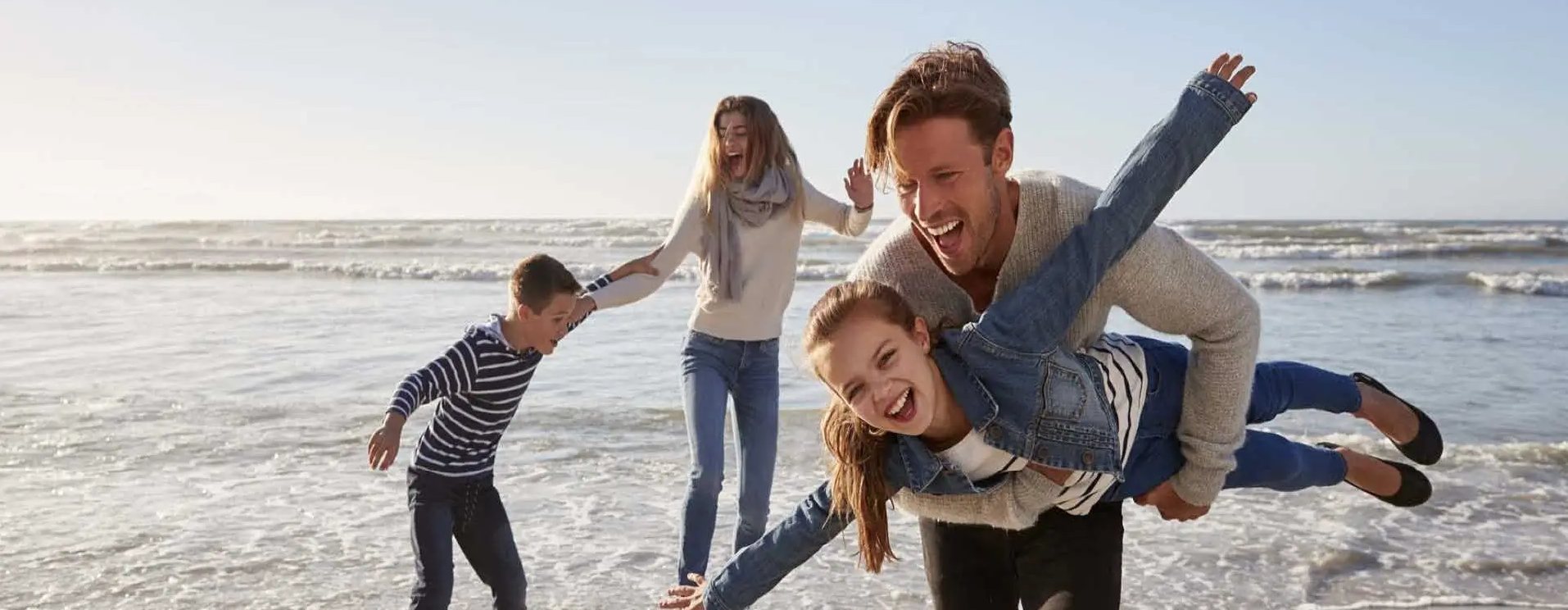 Family is playing joyful at the beach