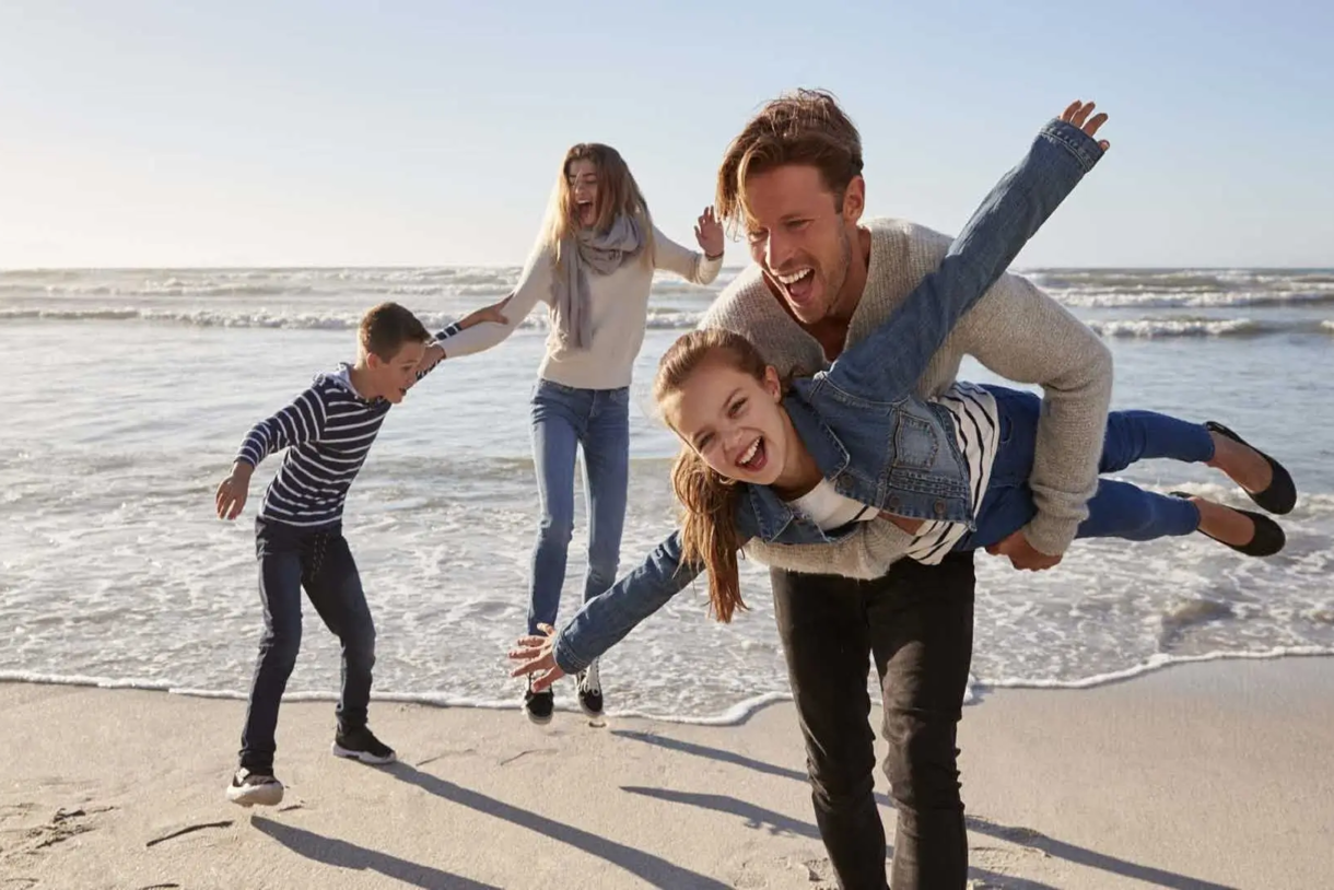 Family is playing joyful at the beach